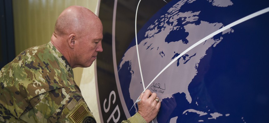 Gen. John Raymond, U.S. Space Force chief of space operations, signs the United States Space Command sign inside of the Perimeter Acquisition Radar building Jan. 10, 2020, on Cavalier Air Force Station, North Dakota.