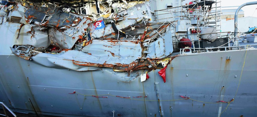 This July 11, 2017, file photo provided by the U.S. Navy shows the USS Fitzgerald in dry dock in Yokosuka, Japan, for repairs and assessment of damage sustained from a June 17 collision with a cargo ship in the waters off of Japan.
