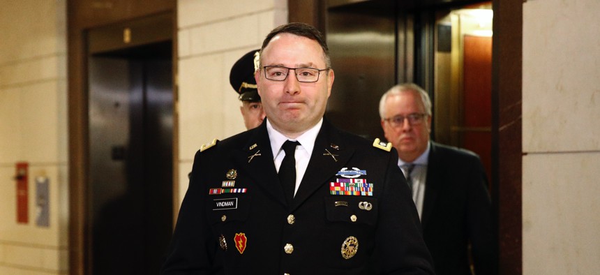 U.S. Army Lt. Col. Alexander Vindman, a military officer at the National Security Council, center, arrives on Capitol Hill in Washington, Tuesday, Oct. 29, 2019, to appear before a House Committee on Foreign Affairs interview regarding impeachment.