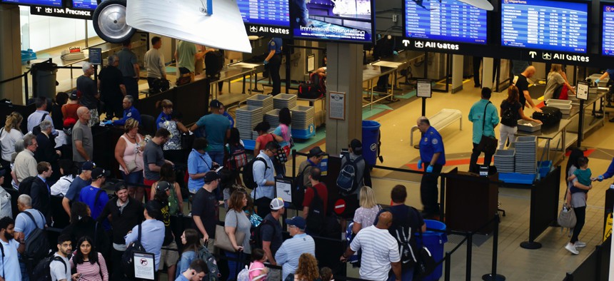 In this June 9, 2019, file photo, travelers make their way through a TSA security checkpoint in Pittsburgh International's Landside terminal in Imperial, Pa.