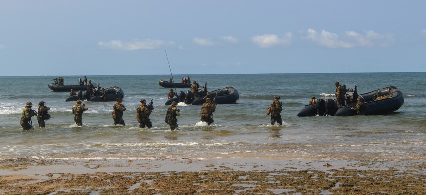 U.S. Marines and Belgian Army soldiers withdraw from the beach during an amphibious landing demonstration during the closing ceremonies for Exercise Tropical Storm in Akanda, Gabon, Dec. 15, 2019.