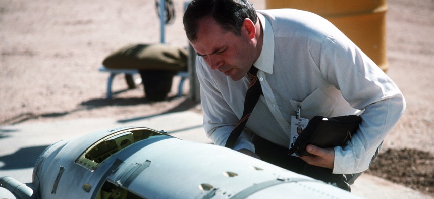A Soviet inspector examines a BGM-109G Tomahawk ground launched cruise missile (GLCM) before its destruction in 1988.