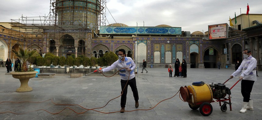 Workers disinfect the shrine of the Shiite Saint Imam Abdulazim to help prevent the spread of the new coronavirus in Shahr-e-Ray, south of Tehran, Iran, Saturday, March, 7, 2020.