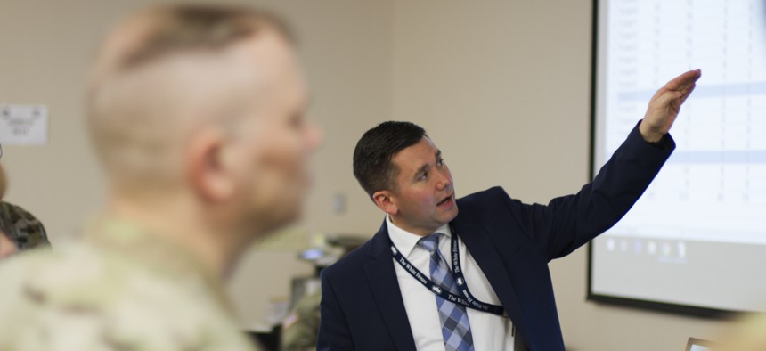 SAIC employee DJ Hovermale explains the network system used during Cyber Shield 19 at Camp Atterbury, Ind., April 16, 2019.