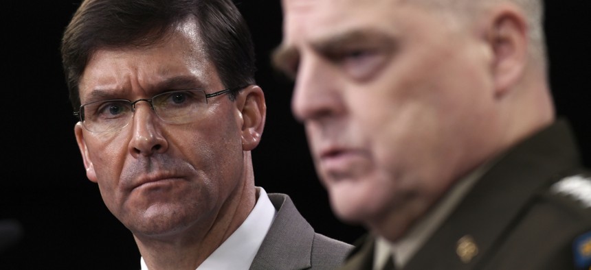 Defense Secretary Mark Esper, left, listens as Chairman of the Joint Chiefs of Staff Army Gen. Mark Milley, right, speaks during a briefing at the Pentagon in Washington, Monday, March 2, 2020.