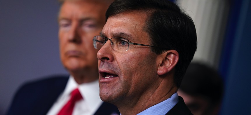 Defense Secretary Mark Esper speaks as President Donald Trump listens during press briefing with the Coronavirus Task Force, at the White House, Wednesday, March 18, 2020, in Washington.