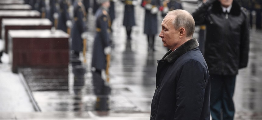 Russian President Vladimir Putin attends a wreath-laying ceremony at the Tomb of the Unknown Soldier, near the Kremlin during the national celebrations of the 'Defender of the Fatherland Day' in Moscow, Russia, Sunday, Feb. 23, 2020.