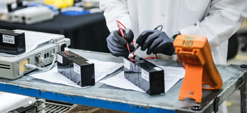 An engineer tests voltage of new batteries at Bloom Energy in Sunnyvale, Calif., a fuel cell generator company that has switched over to refurbishing ventilators.