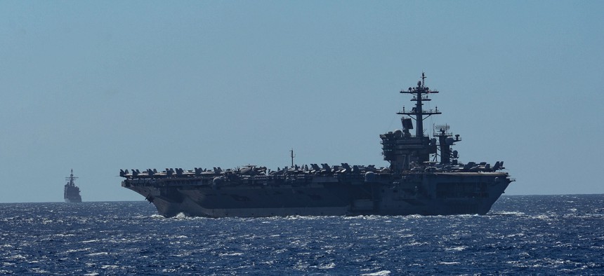 The aircraft carrier USS Theodore Roosevelt (CVN 71) and the Ticonderoga-class guided-missile cruiser USS Bunker Hill (CG 52) transit the Philippine Sea Feb. 29, 2020.