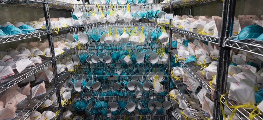 Protective masks hang in a decontamination unit at the Battelle N95 decontamination site during the coronavirus pandemic, Saturday, April 11, 2020, in Somerville, Mass