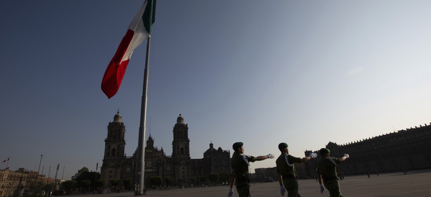 Mexican soldiers leave the Zocalo square after deploying the national flag in Mexico City, Sunday, March 22, 2020.