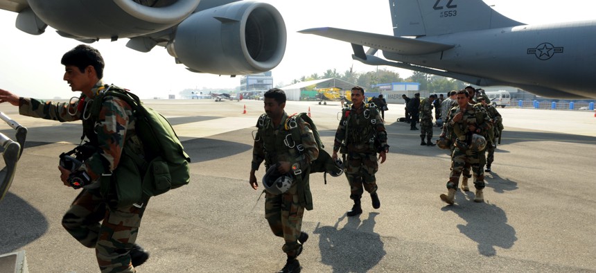 Soldiers of the U.S. Army's 1st Special Forces Group and India's 2nd Parachute Regiment (Special Forces) and National Security Guard load into a Pacific Air Forces C-17 Globemaster III for a parachuting demonstration at Bengaluru, India, in 2015.