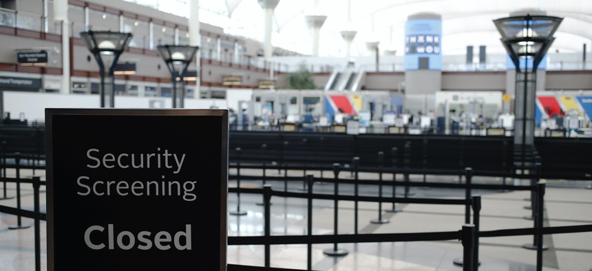 A sign stands outside the ropes of the closed north security checkpoint in the main terminal at Denver International Airport Thursday, April 23, 2020, in Denver.