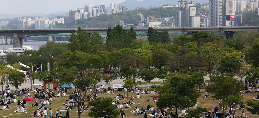 People at a public park on the Han River in Seoul, South Korea, Thursday, April 30, 2020.