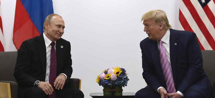 In this June 28, 2019, file photo, President Donald Trump, right, meets with Russian President Vladimir Putin during a bilateral meeting on the sidelines of the G-20 summit in Osaka, Japan. 