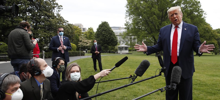 President Donald Trump speaks with reporters on the South Lawn of the White House as he departs on Marine One, Thursday, May 14, 2020, in Washington. 