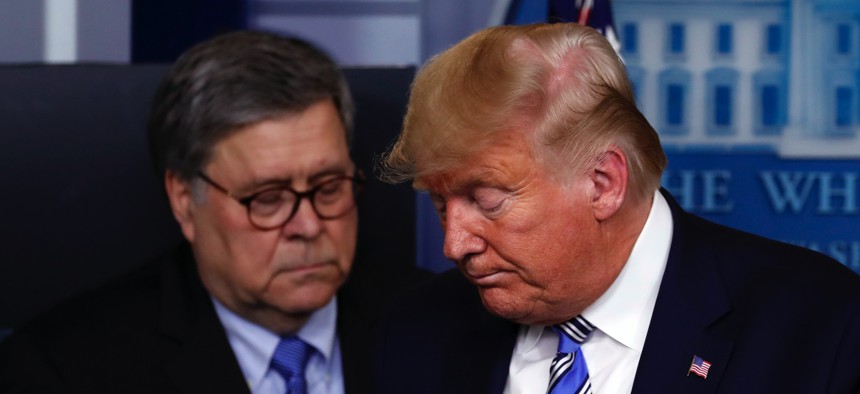 President Donald Trump moves from the podium to allow Attorney General William Barr to speak about the coronavirus in the James Brady Briefing Room, Monday, March 23, 2020, in Washington.