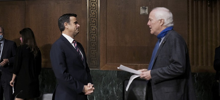 Rep. John Ratcliffe, R-Texas, talks with Sen. John Cornyn, R-Texas at the top of a Senate Intelligence Committee nomination hearing on Capitol Hill in Washington, Tuesday, May. 5, 2020. The panel is considering Ratcliffe's nomination.