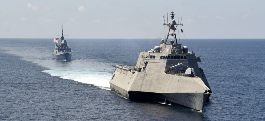 The Independence-variant littoral combat ship USS Gabrielle Giffords (LCS 10), front, exercises with the Republic of Singapore navy Formidable-class multi-role stealth frigate RSS Steadfast (FFS 70) in the South China Sea, May 25, 2020.