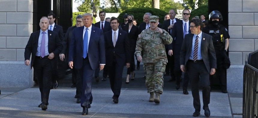 After tear gassing lawful protestors, President Donald Trump departs the White House with Defense Secretary Mark Esper and Joint Chiefs Chairman Gen. Mark Milley for a photo op at St. John's Church, Monday, June 1, 2020, in Washington.