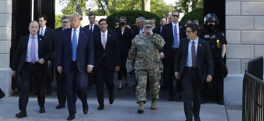 Chairman of the Joint Chiefs Gen. Mark Milley and Defense Secretary Mark Esper accompany President Donald Trump from the gates of the White House to visit St. John's Church across Lafayette Park Monday, June 1, 2020, in Washington.