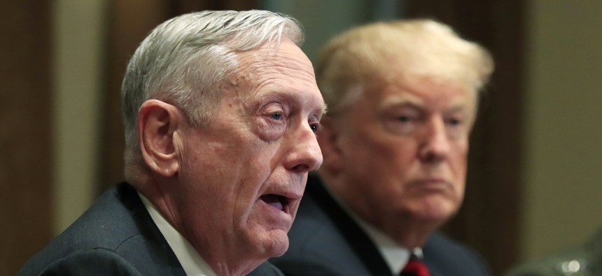 In this Oct. 23, 2018 file photo, Defense Secretary Jim Mattis speaks beside President Donald Trump, during a briefing with senior military leaders in the Cabinet Room at the White House in Washington. 
