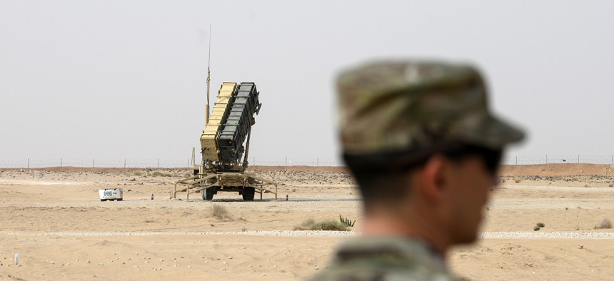 A member of the U.S. Air Force stands near a Patriot missile battery at the Prince Sultan air base in al-Kharj, central Saudi Arabia, Thursday, February 20, 2020.