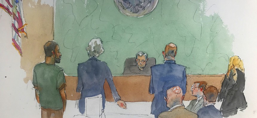 In this courtroom drawing, Najibullah Zazi, left appears at federal court in the Brooklyn borough of New York, Thursday, May 2, 2019, where he was sentenced to ten years in prison for plotting to bomb the New York subway system in 2009.