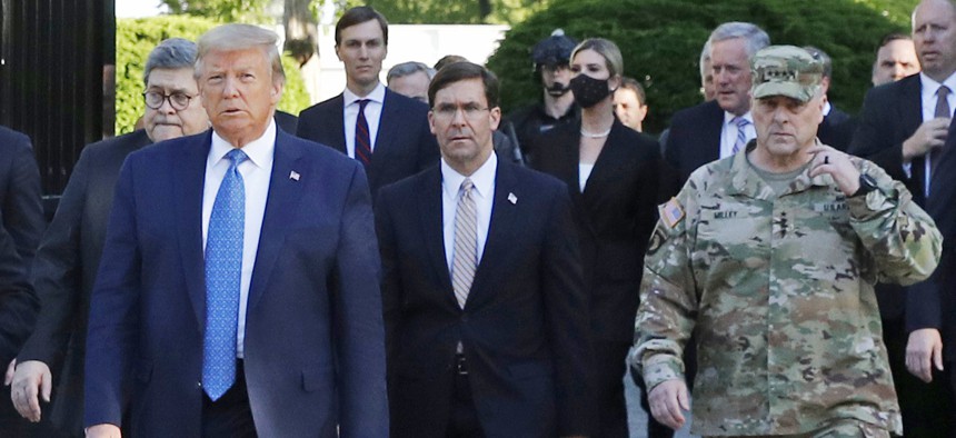 President Donald Trump leaves the White House for a photo op. Walking behind Trump, right, is Gen. Mark Milley, chairman of the Joint Chiefs of Staff.