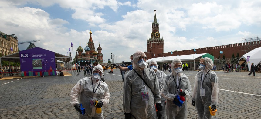 Volunteers wearing face masks, gloves and protective gear to protect against coronavirus in Moscow, Russia, Saturday, June 6, 2020. 