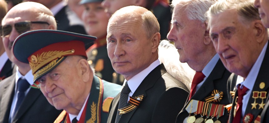 In this file photo taken on Wednesday, June 24, 2020, Russian President Vladimir Putin, center, watches the Victory Day military parade marking the 75th anniversary of the Nazi defeat in Moscow.