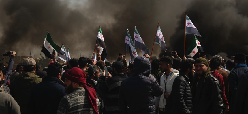 Syrians block main highway in Neyrab, Sunday, March 15, 2020 as they protest agreement on joint Turkish and Russian patrols in northwest Syria. 