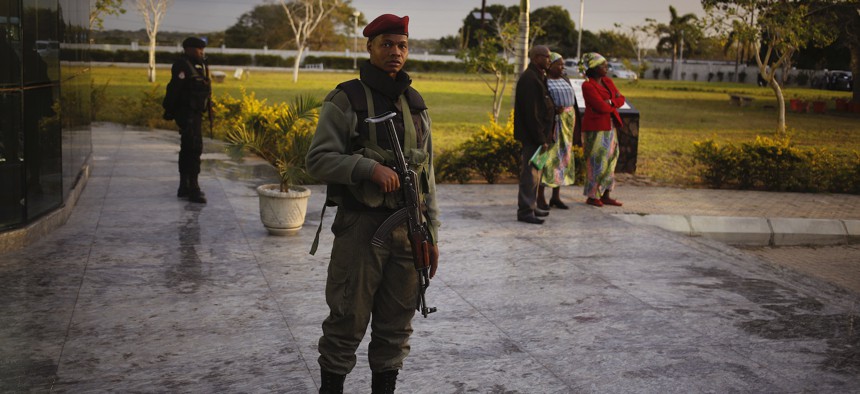 A Mozambican soldier provide security before the arrival of India's Prime Minister Narendra Modi at a technical school in Maluana, Mozambique, Thursday, July 7, 2016