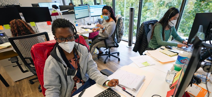 Contact tracers, from left to right, Christella Uwera, Dishell Freeman and Alejandra Camarillo work at Harris County Public Health contact tracing facility Thursday, June 25, 2020, in Houston. 