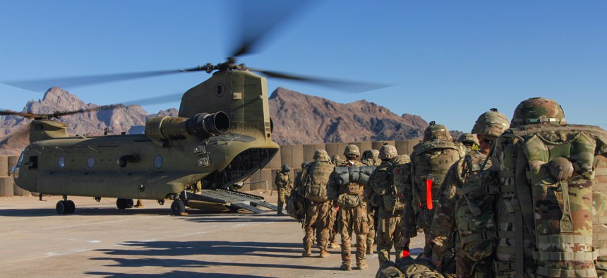 Iowa National Guard and 10th Mountain Division troops load onto a Chinook helicopter to head out and execute missions across the Combined Joint Operations Area-Afghanistan in January 2019.