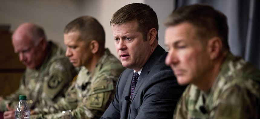 Secretary of the Army Ryan McCarthy, center, accompanied by Col. Darrin Cox, left, Sgt. Maj. Michael Grinston, second from left, and Gen. James McConville, Chief of Staff of the Army, speaks at a news conference at U.S. Army Medical Research and Developme