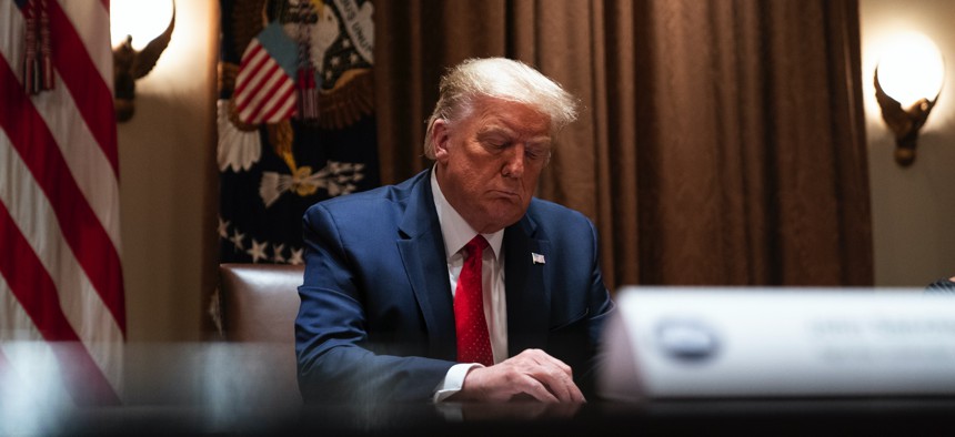 President Donald Trump listens during a meeting with Hispanic leaders in the Cabinet Room of the White House, Thursday, July 9, 2020, in Washington. 