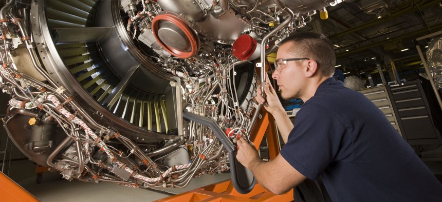 A Pratt & Whitney employee works on an engine in Middletown, Connecticut.