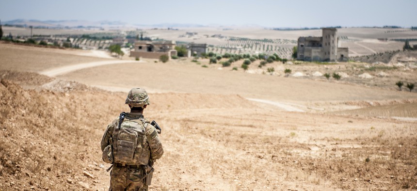 A U.S. soldier provides security near a village outside Manbij, Syria, in 2018.