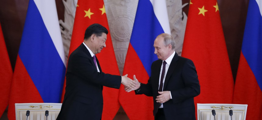 Russian President Vladimir Putin and Chinese President Xi Jinping attend a welcome ceremony prior to their talks in the Kremlin in Moscow, Russia, Wednesday, June 5, 2019. 