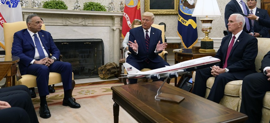 President Donald Trump meets with Iraqi Prime Minister Mustafa al-Kadhimi in the Oval Office of the White House, Thursday, Aug. 20, 2020, in Washington. Sitting at right is Vice President Mike Pence.