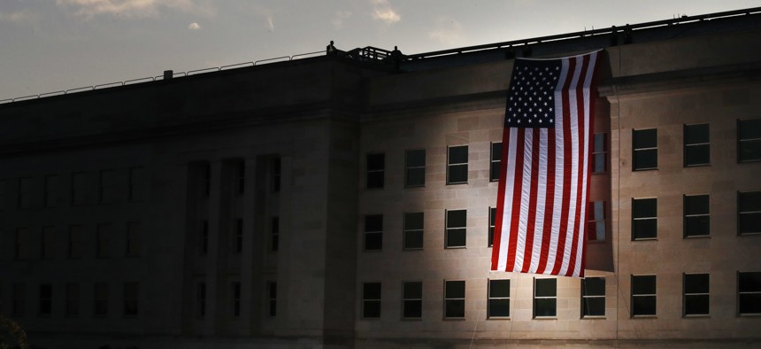 In this file photo, a U.S. flag is unfurled at sunrise at the Pentagon on the 16th anniversary of the September 11th attacks, in 2017.