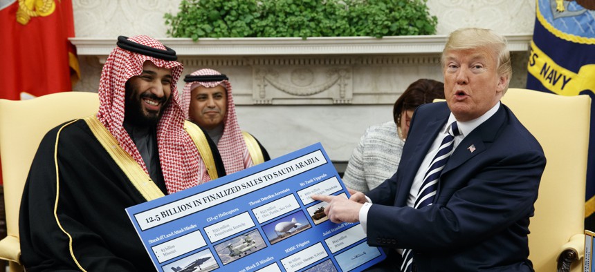In this March 20, 2018, file photo, President Donald Trump shows a chart highlighting arms sales to Saudi Arabia during a meeting with Saudi Crown Prince Mohammed bin Salman in the Oval Office of the White House in Washington. 