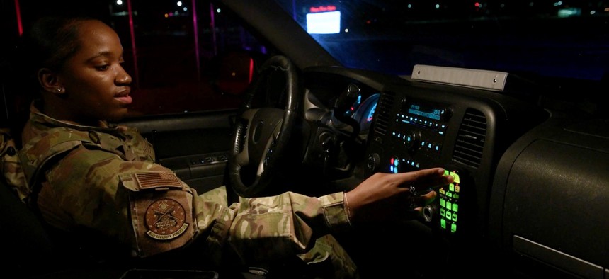 A defender from the 432nd Security Forces Squadron turns on a vehicle’s red and blue lights during their night shift at Creech Air Force Base, Nevada, May 8, 2020. 