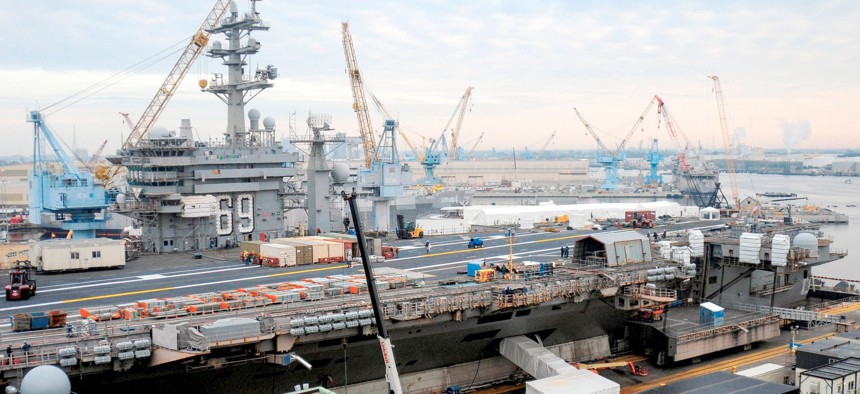 The aircraft carrier USS Dwight D. Eisenhower (CVN 69) sits in dry dock during a 14-month scheduled docking planned incremental availability at Norfolk Naval Shipyard.