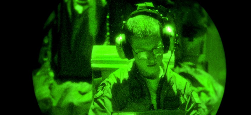 An aircrew member from the 522nd Special Operations Squadron reviews his in-flight checklist aboard an MC-130J Commando II from Cannon Air Force Base, N.M., Aug. 22, 2012. 
