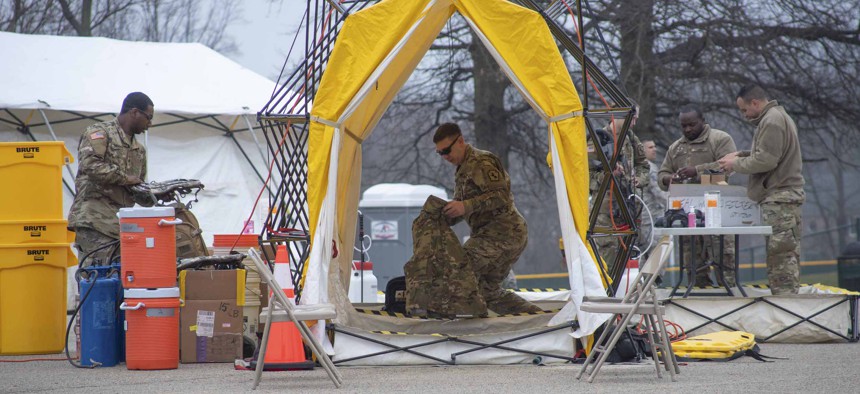 Pennsylvania Air National Guardsmen set up gear at a mass coronavirus test center in Upper Dublin Township, Pa., March 20, 2020. 