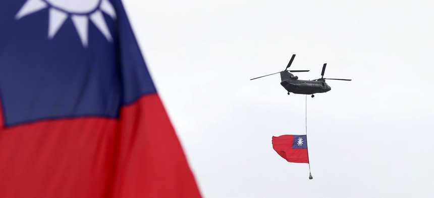 Helicopters fly Taiwan's flag during the National Day celebrations in Taipei on Oct. 10, 2020.
