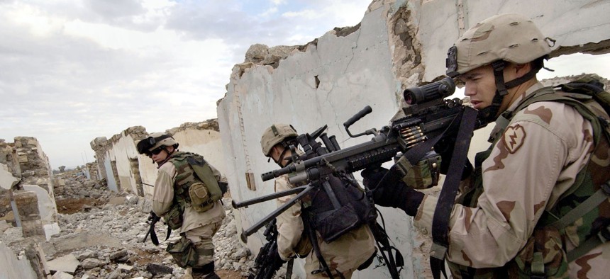 U.S. Army soldiers search for insurgents suspected of planting a roadside bomb in Mosul, Iraq Sunday, Nov. 21, 2004.