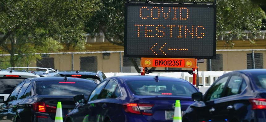 Cars line up at a COVID-19 testing site at Tropical Park, Saturday, Nov. 14, 2020, in Miami.